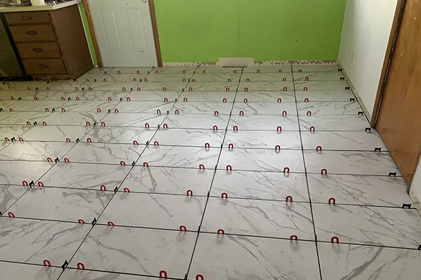 Tile floor installation in progress by Cedar Rapids Flooring and Remodel